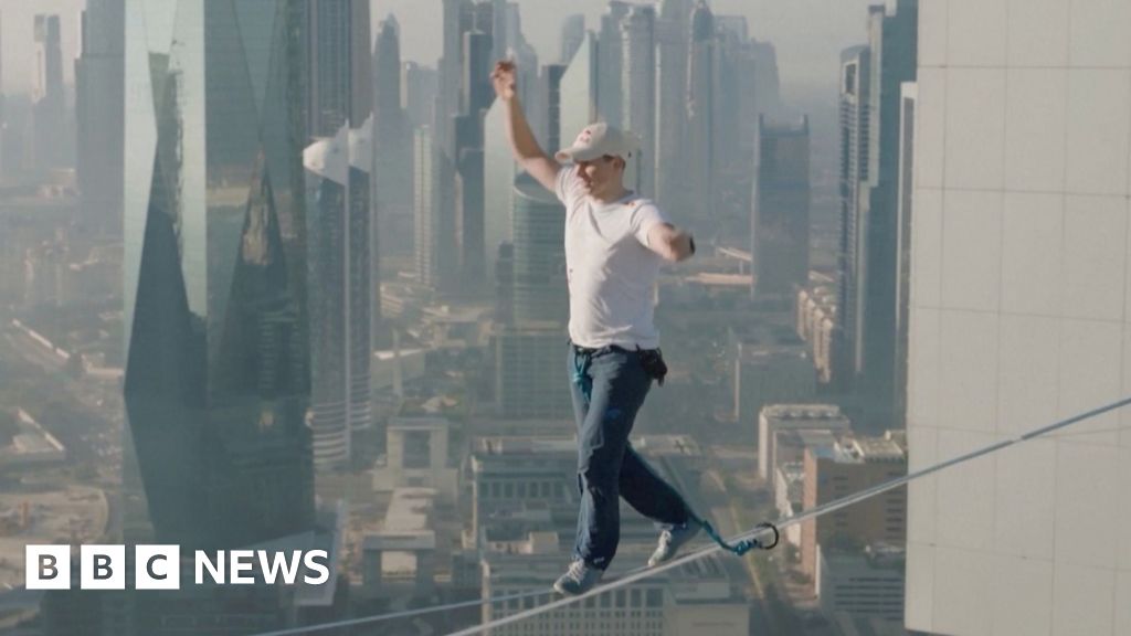 Moment slackliner conquers highline walk between Dubai towers