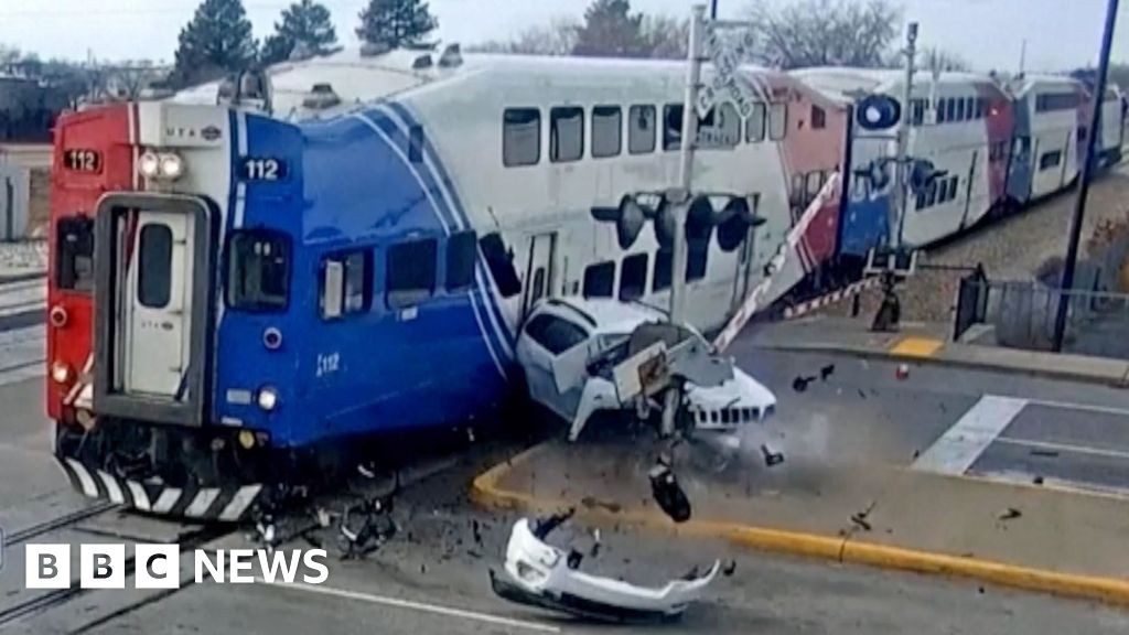 Moment SUV driver narrowly escapes train collision